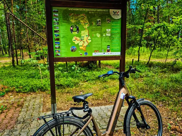 Rower elektryczny przy tablicy szlaku Green Velo